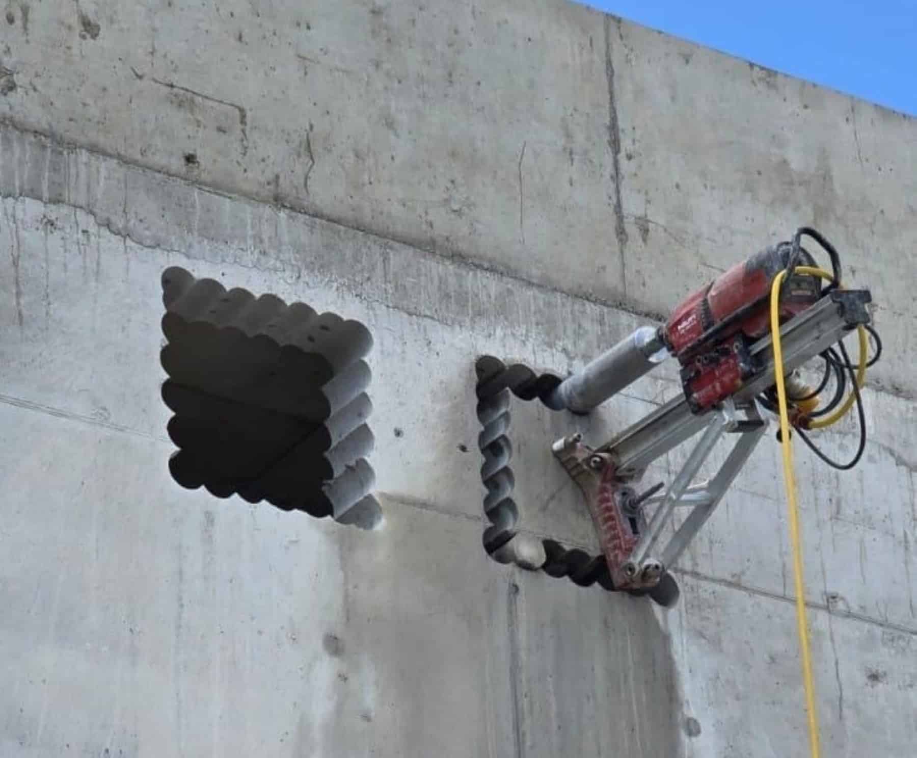 Diamond Stitch Drilling Drilling machine cutting a square hole in a concrete wall using diamond stitch drilling technique.